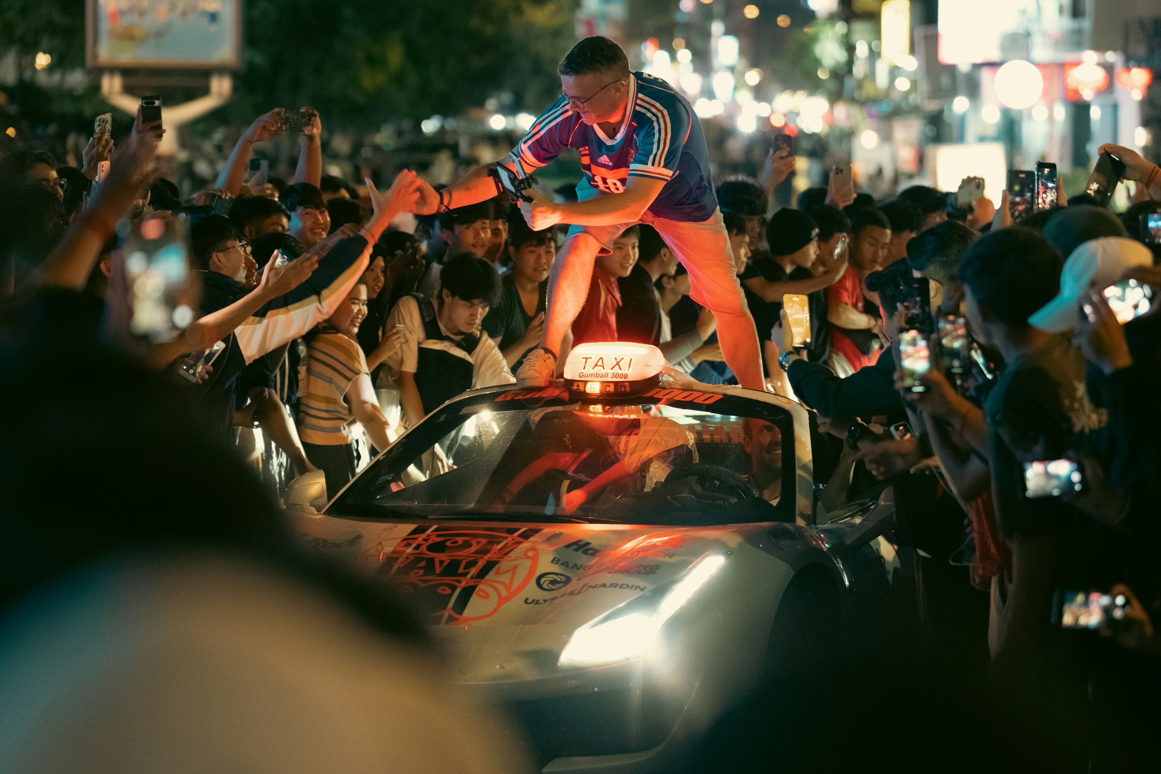 Fans celebrate on a taxi after a win.