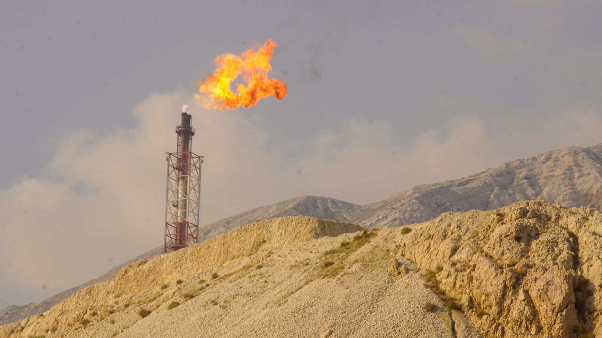 A flare burns brightly from a tower.