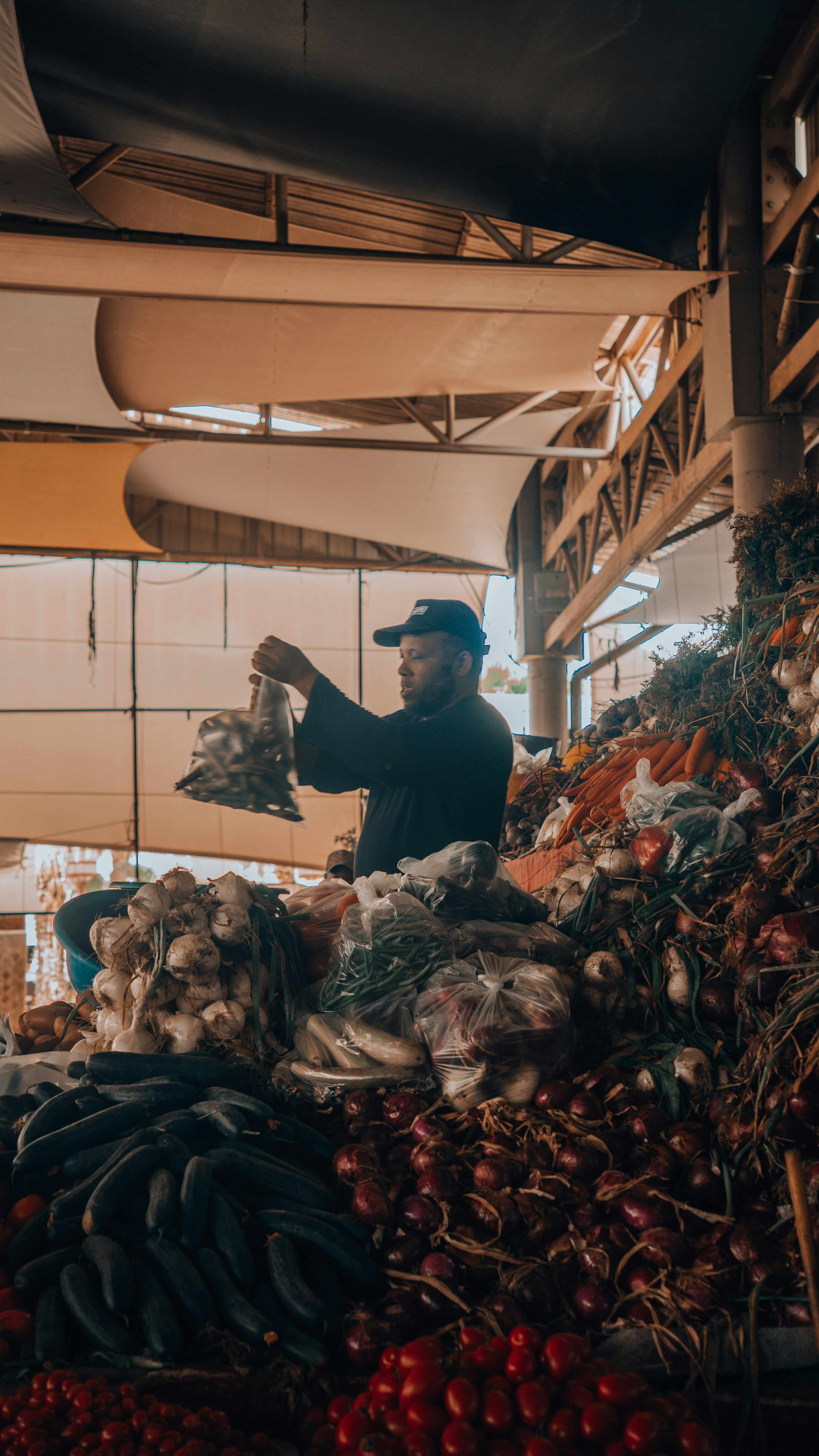 A vendor displays produce at a bustling market.
