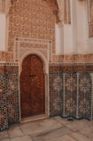 Ornate islamic architecture showcases a beautiful wooden door.