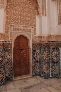 Ornate islamic architecture showcases a beautiful wooden door.