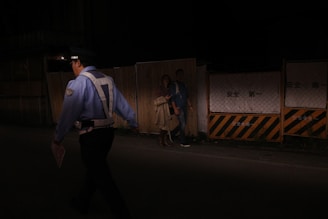 A police officer approached a confrontation at night.