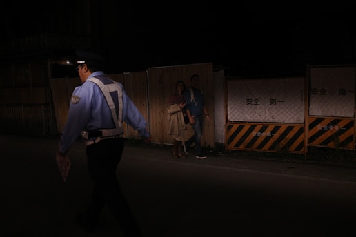 A police officer approached a confrontation at night.