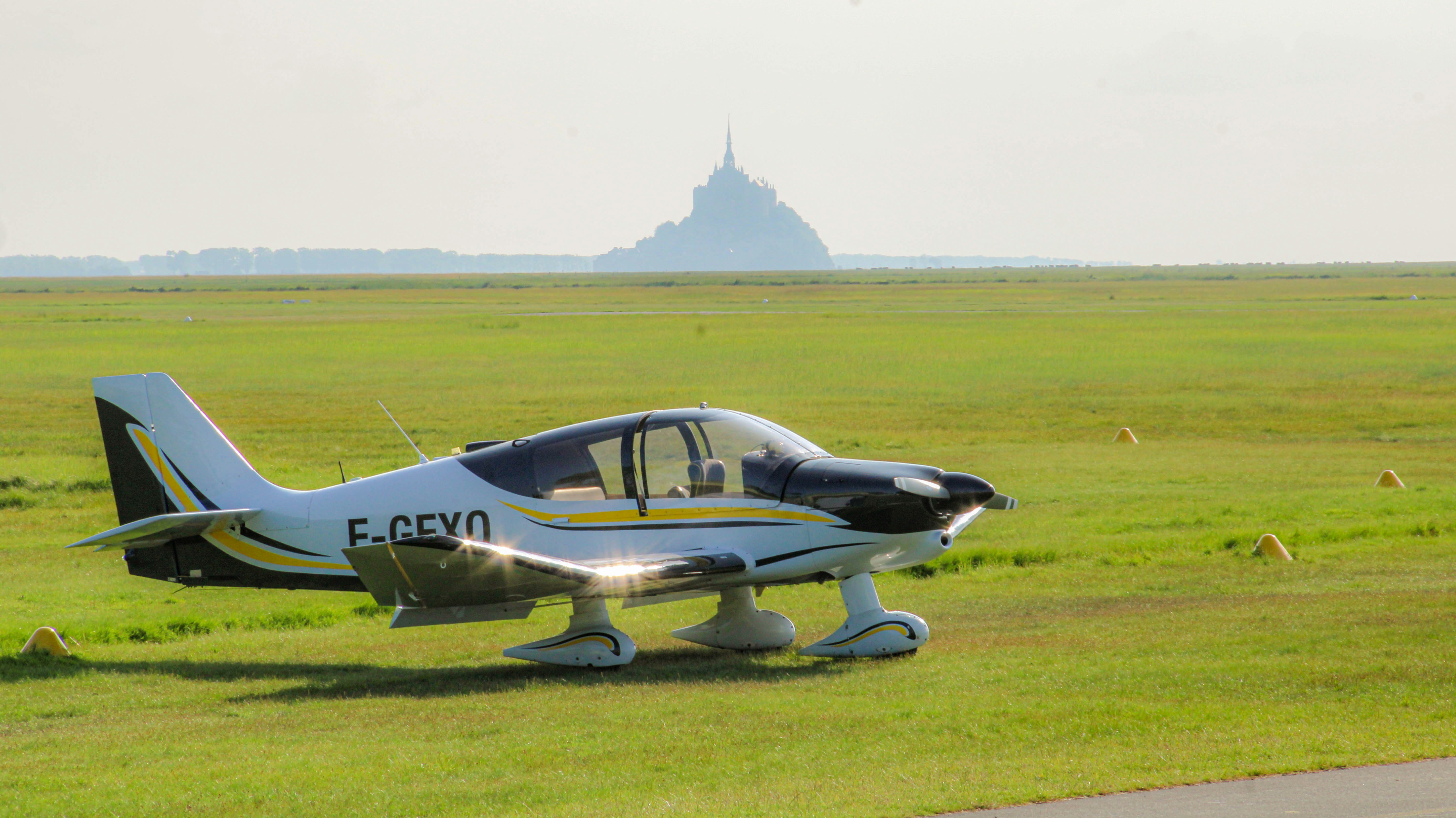 A small airplane sits in a field.