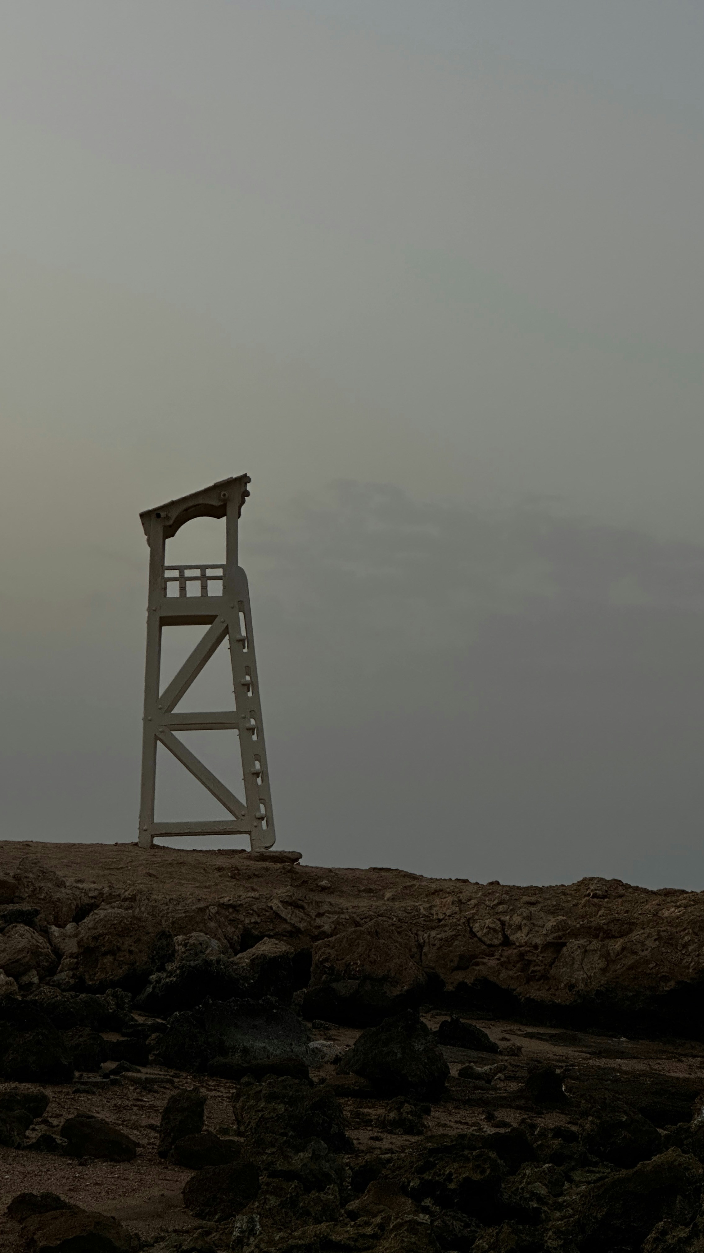 A lifeguard tower stands guard over the rocks.