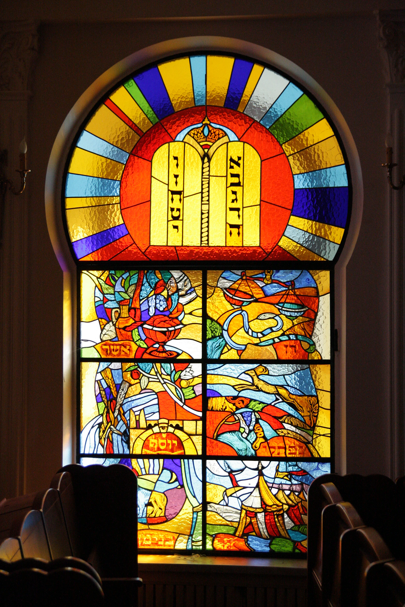 Colorful stained glass window in a synagogue interior