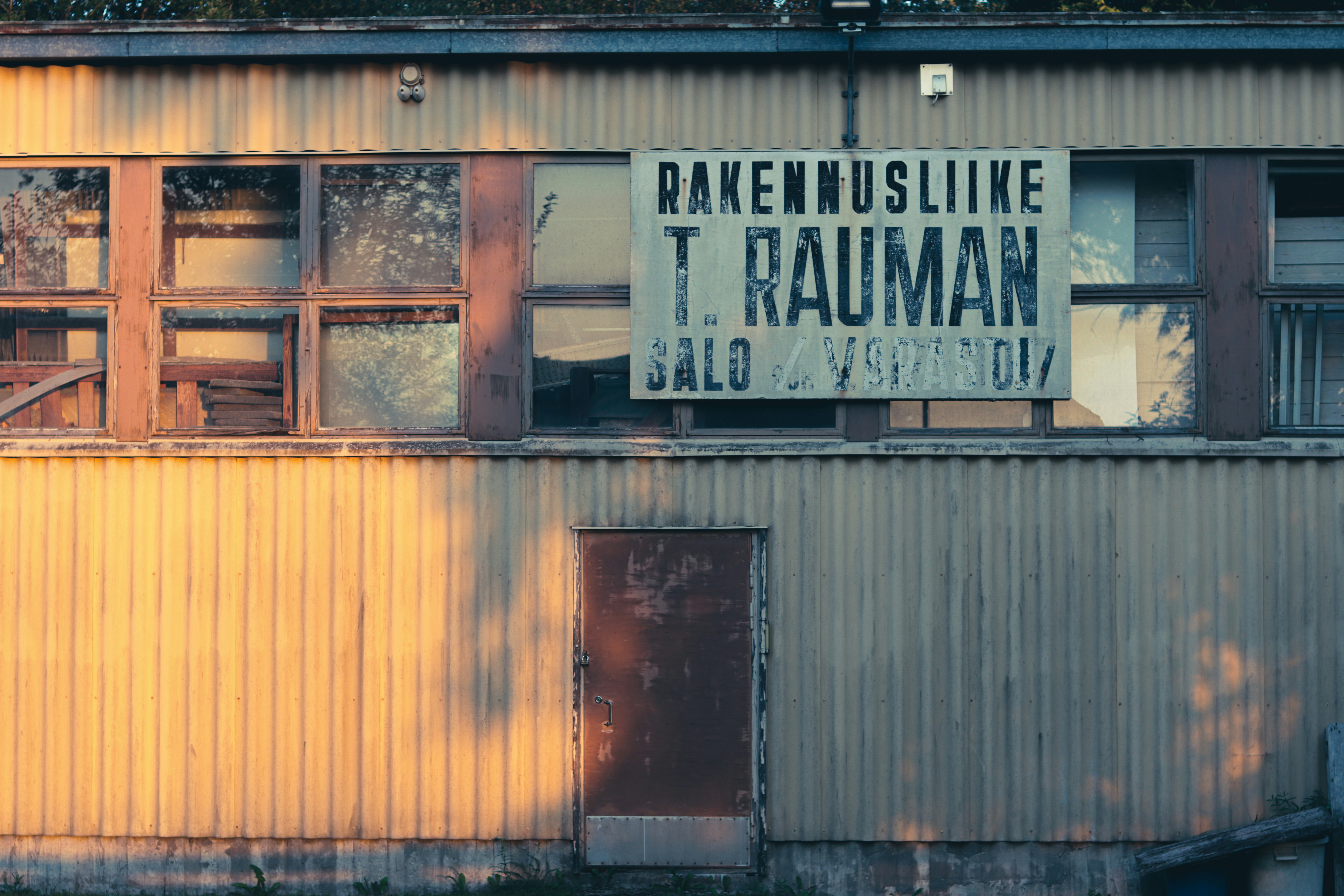 An old building with a sign in a foreign language.
