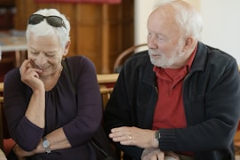 An older couple is talking and smiling.