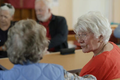 Older women are conversing at a table