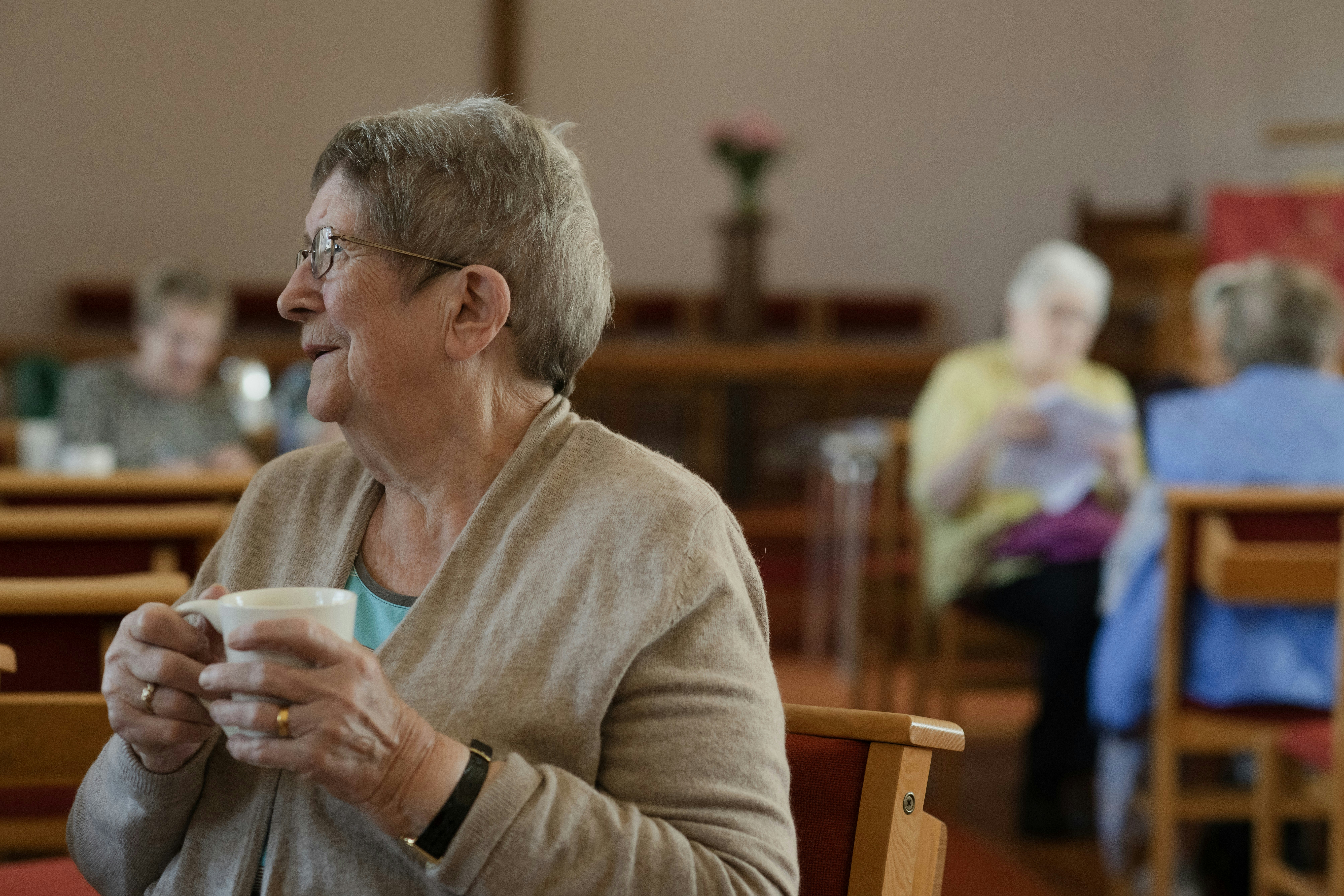 Older women gather for coffee or tea.