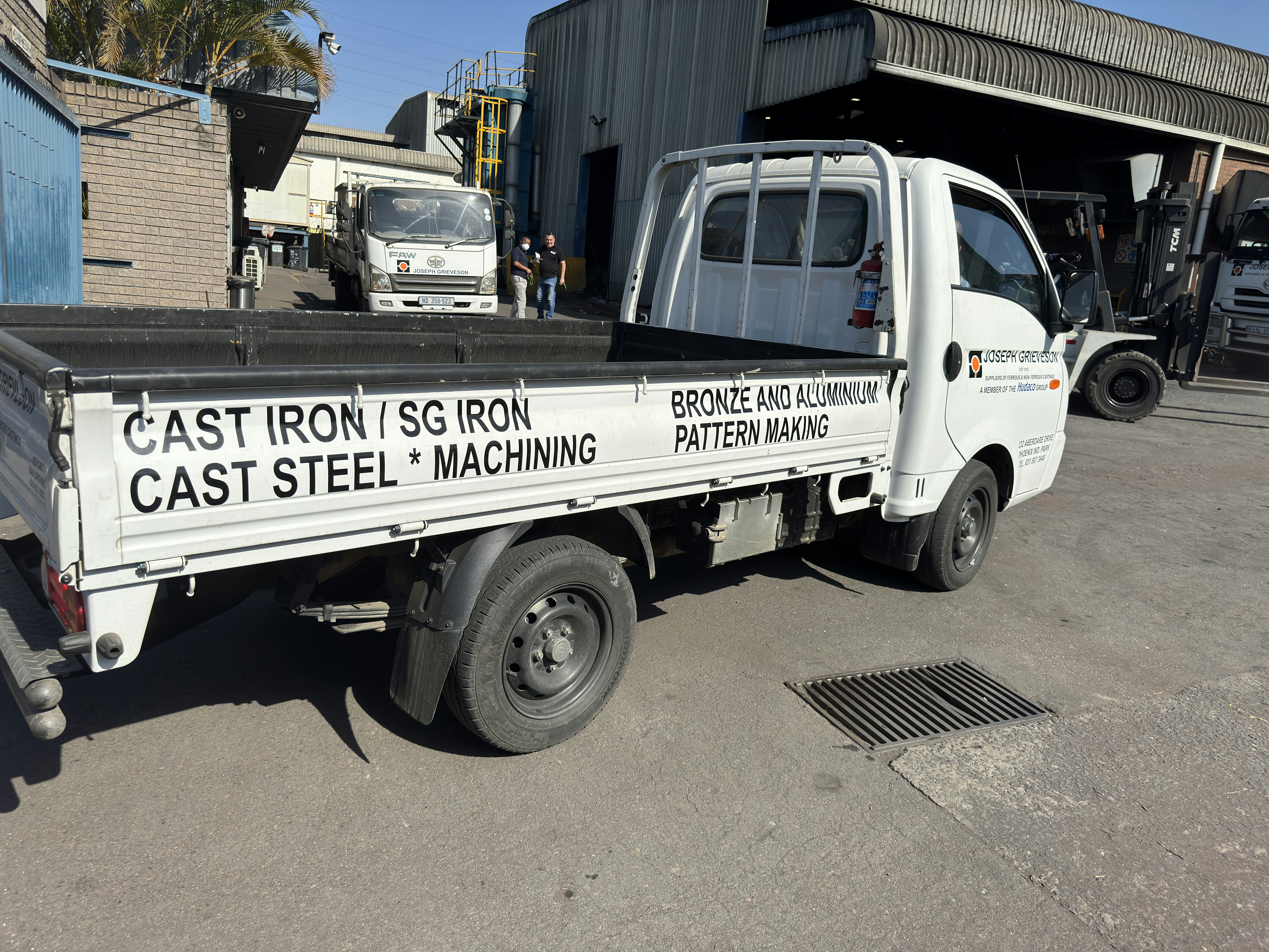 A white truck displays metal fabrication services.