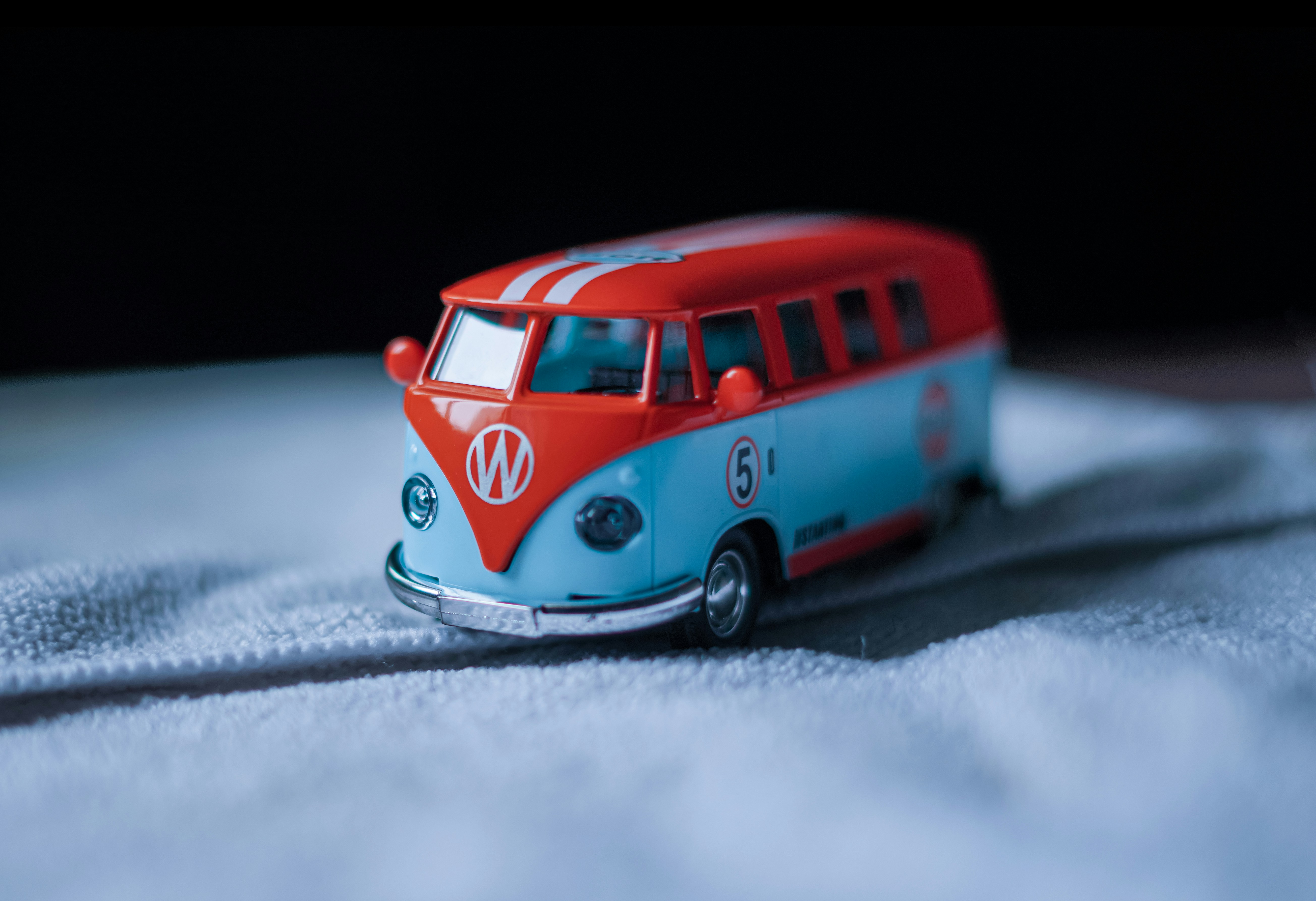 Here is a single-sentence caption: a colorful, vintage volkswagen bus toy.