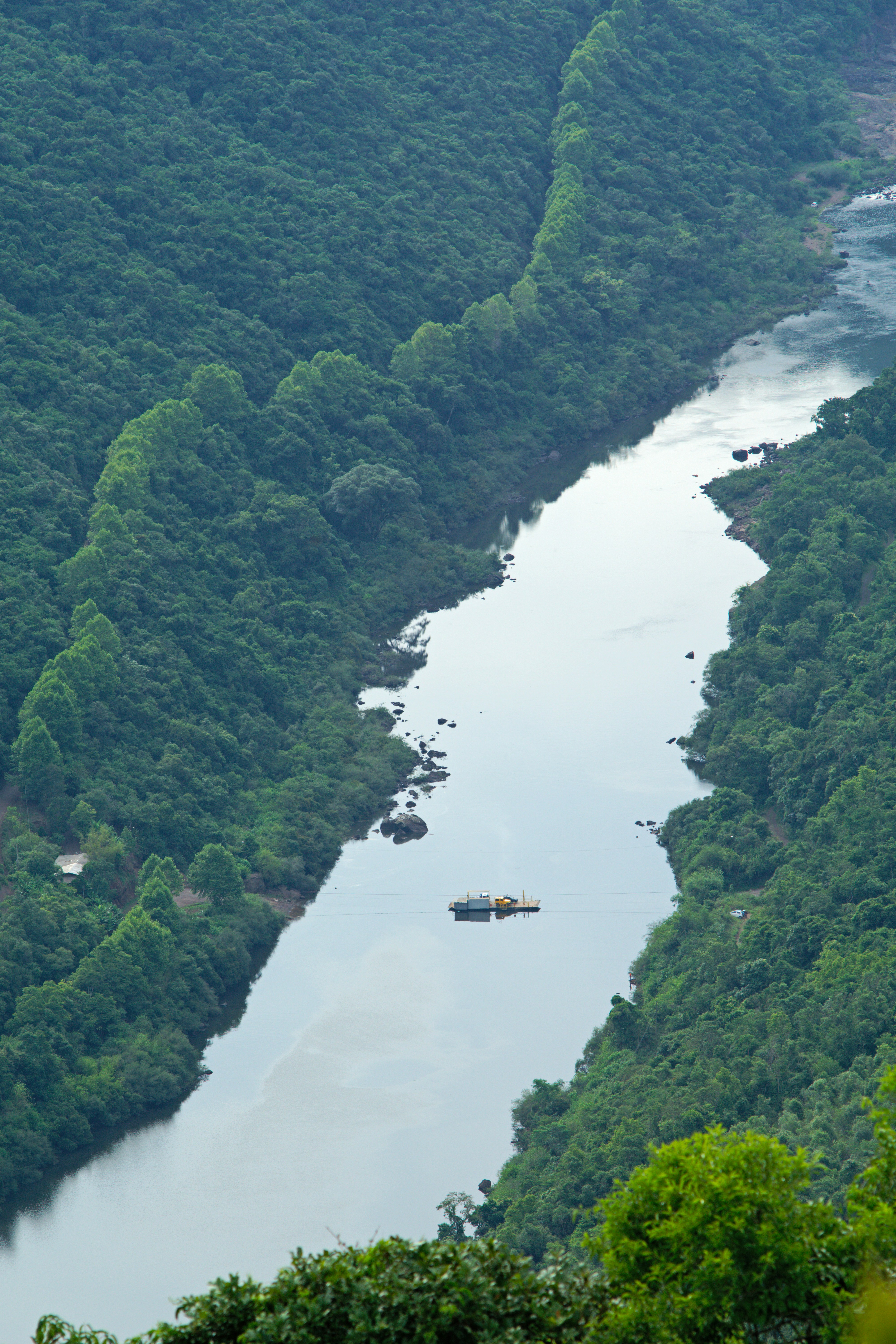 A river flows through lush green mountains.