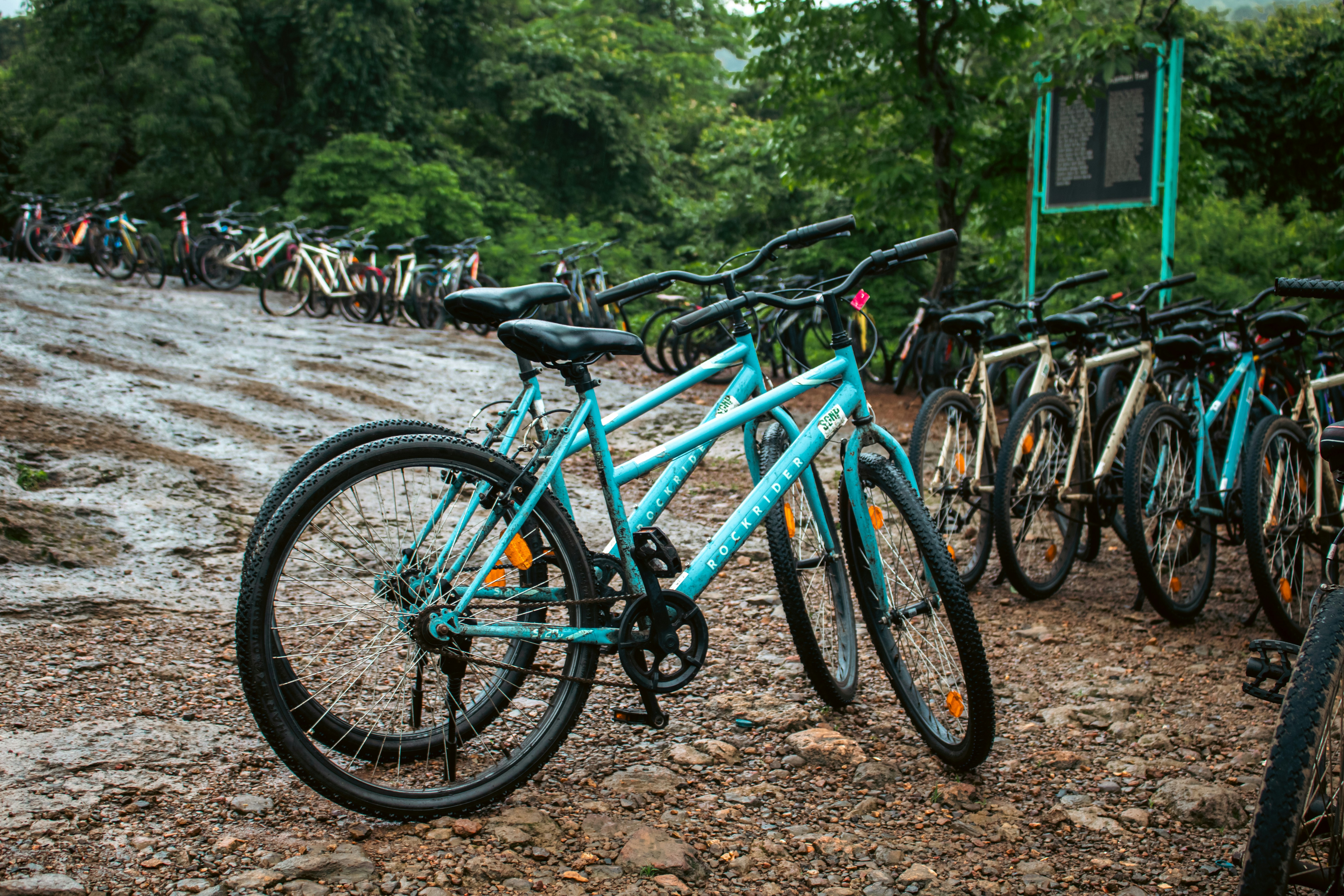 Bicycles are parked outdoors on a rainy day.