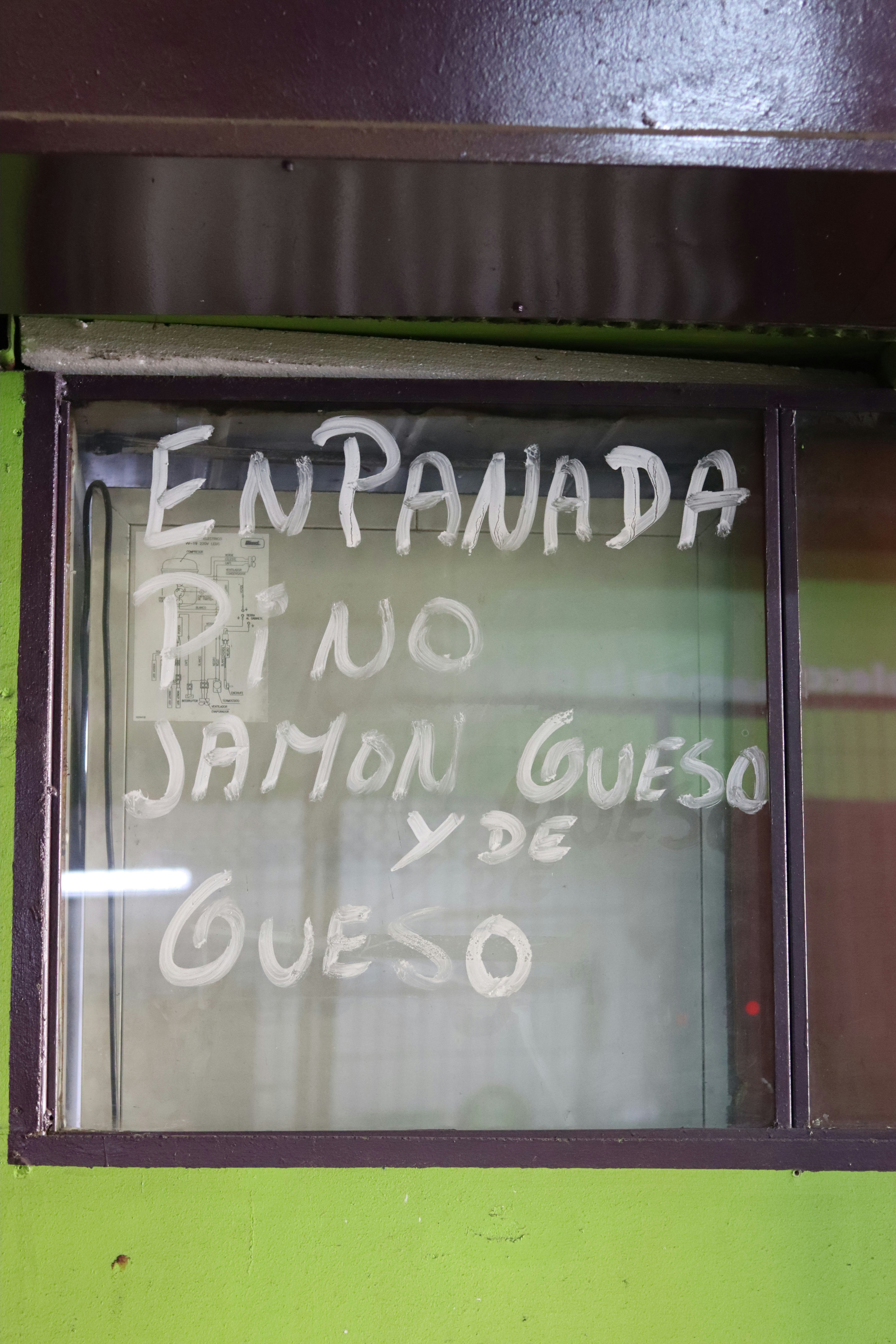 Empanadas, including fillings like ham and cheese, are offered.