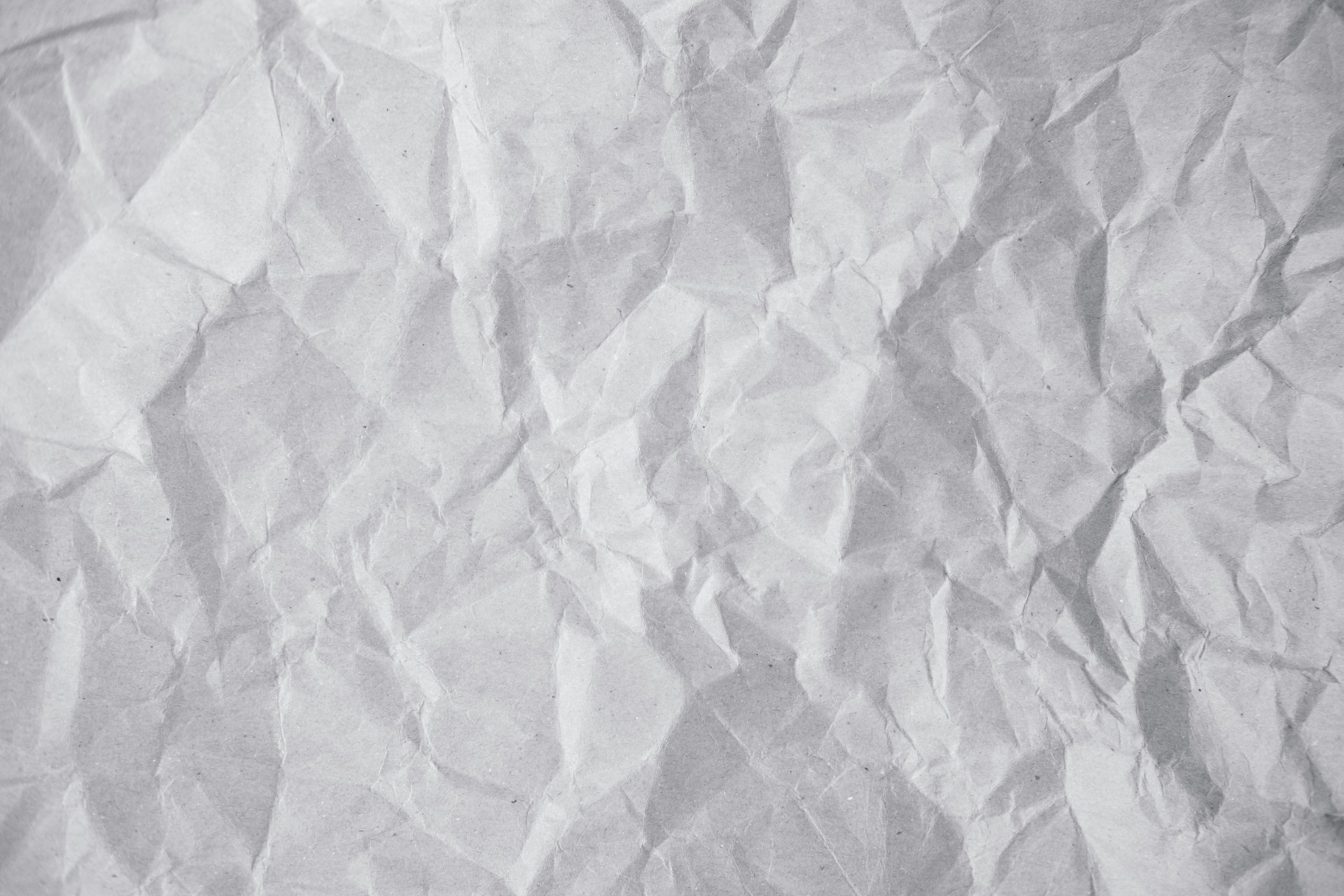 Crumpled white paper texture fills the whole frame.