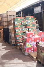 Boxes of fruit are stacked on pallets.