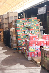 Boxes of fruit are stacked on pallets.
