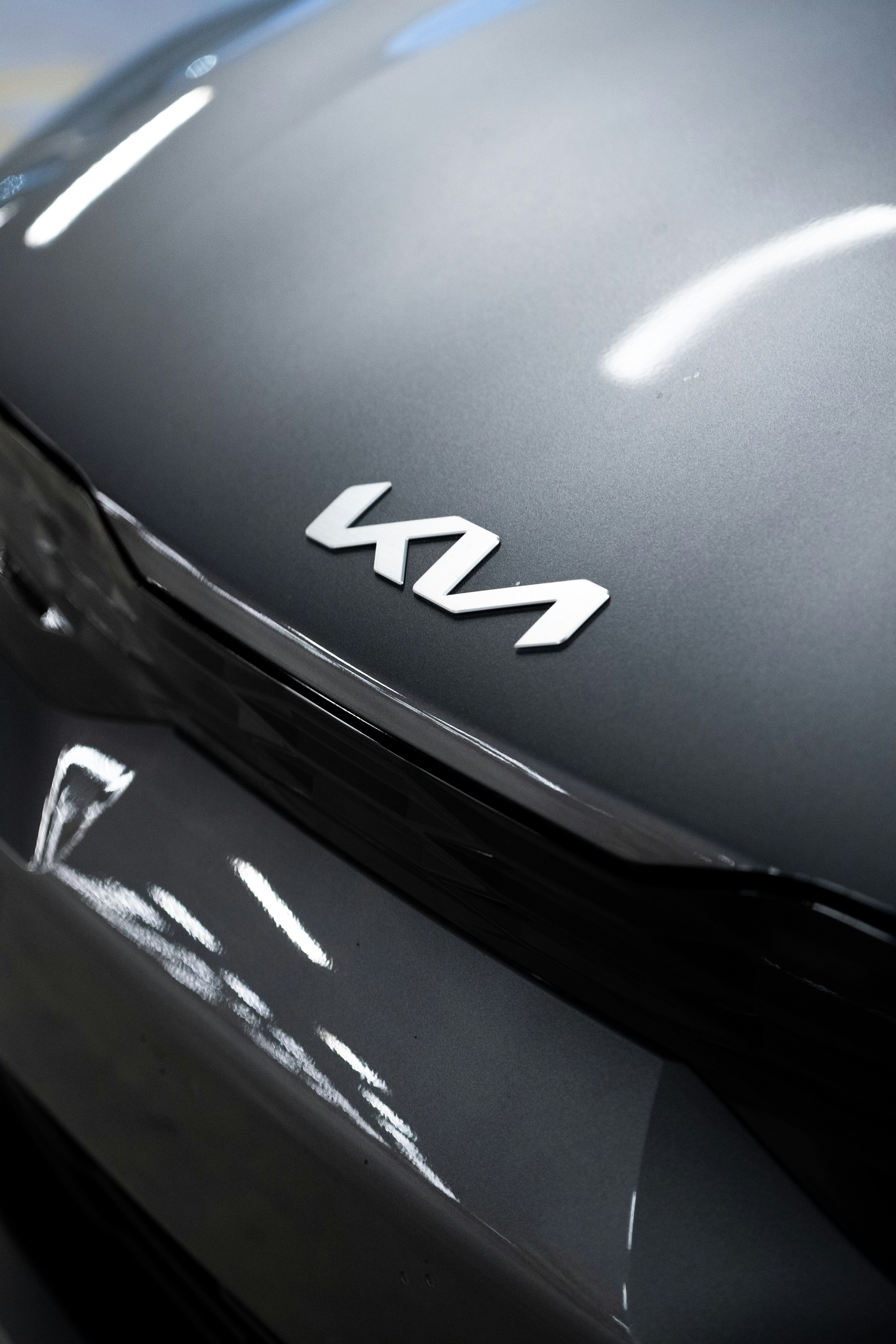 A close-up of the kia emblem.