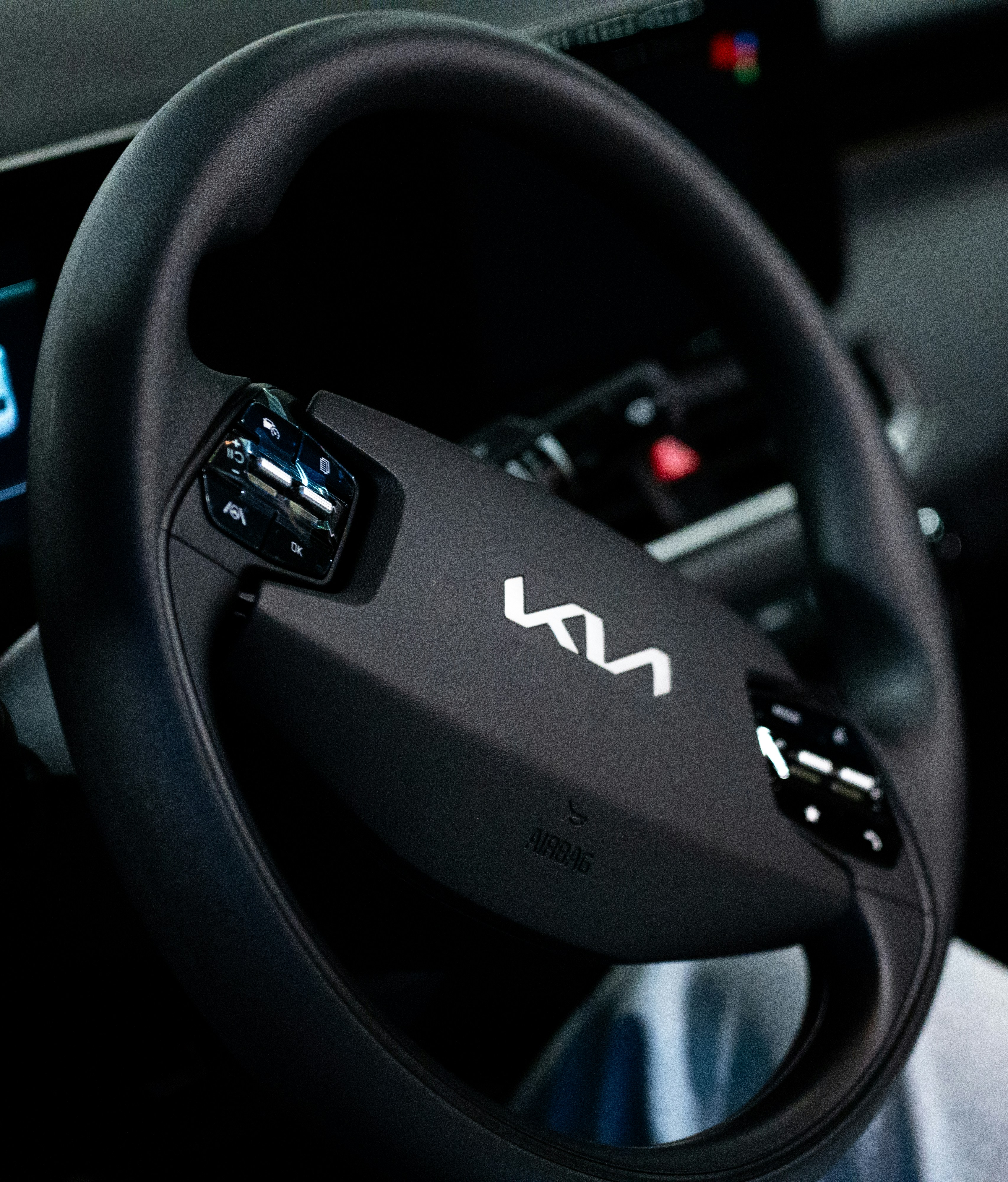 A kia steering wheel with controls is shown.