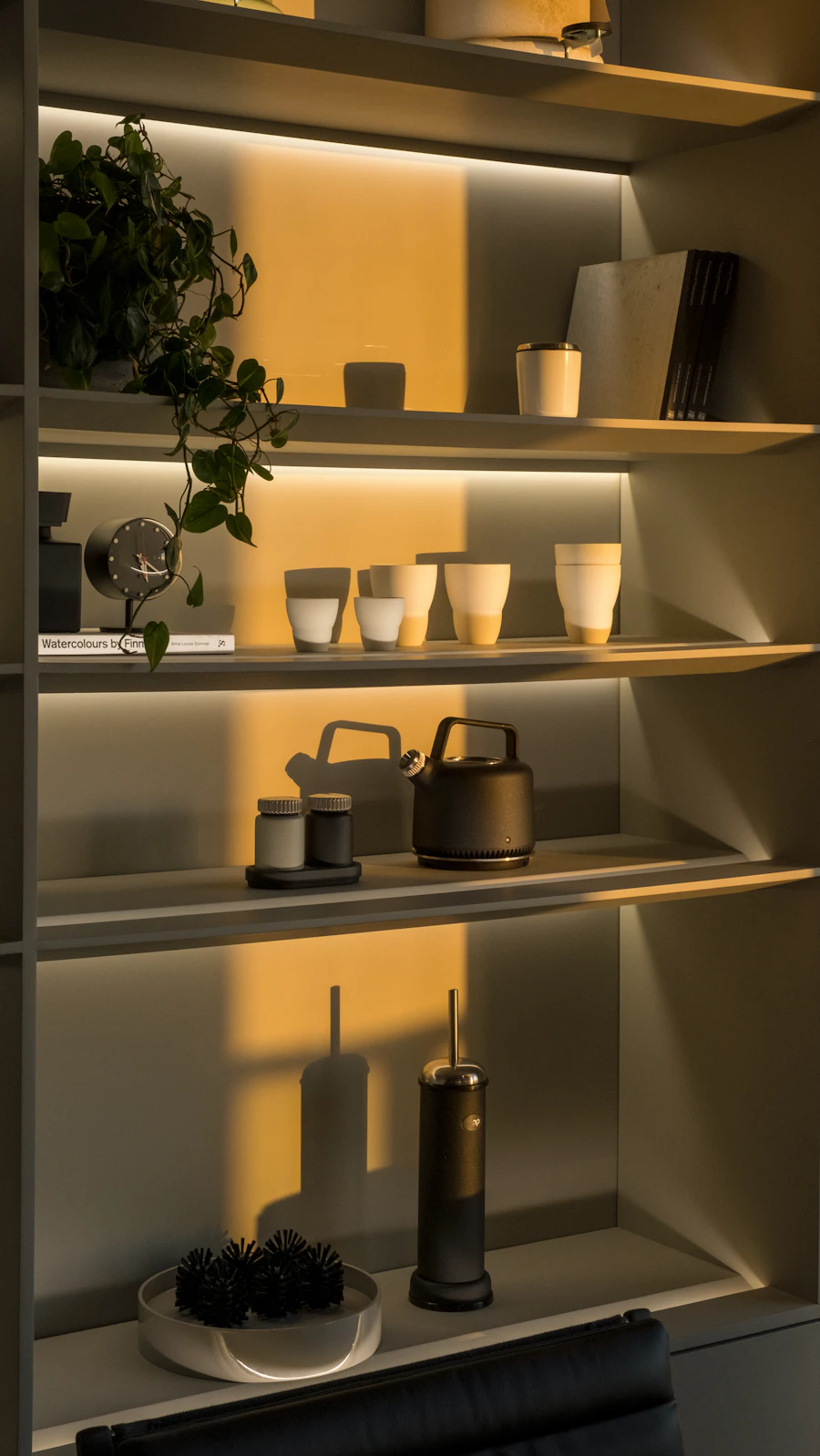 Warm shelf display with vessels and decor styling