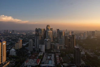 A city skyline against a warm sunset.