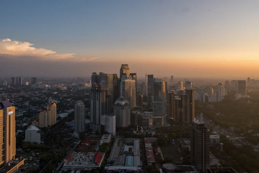 A city skyline against a warm sunset.