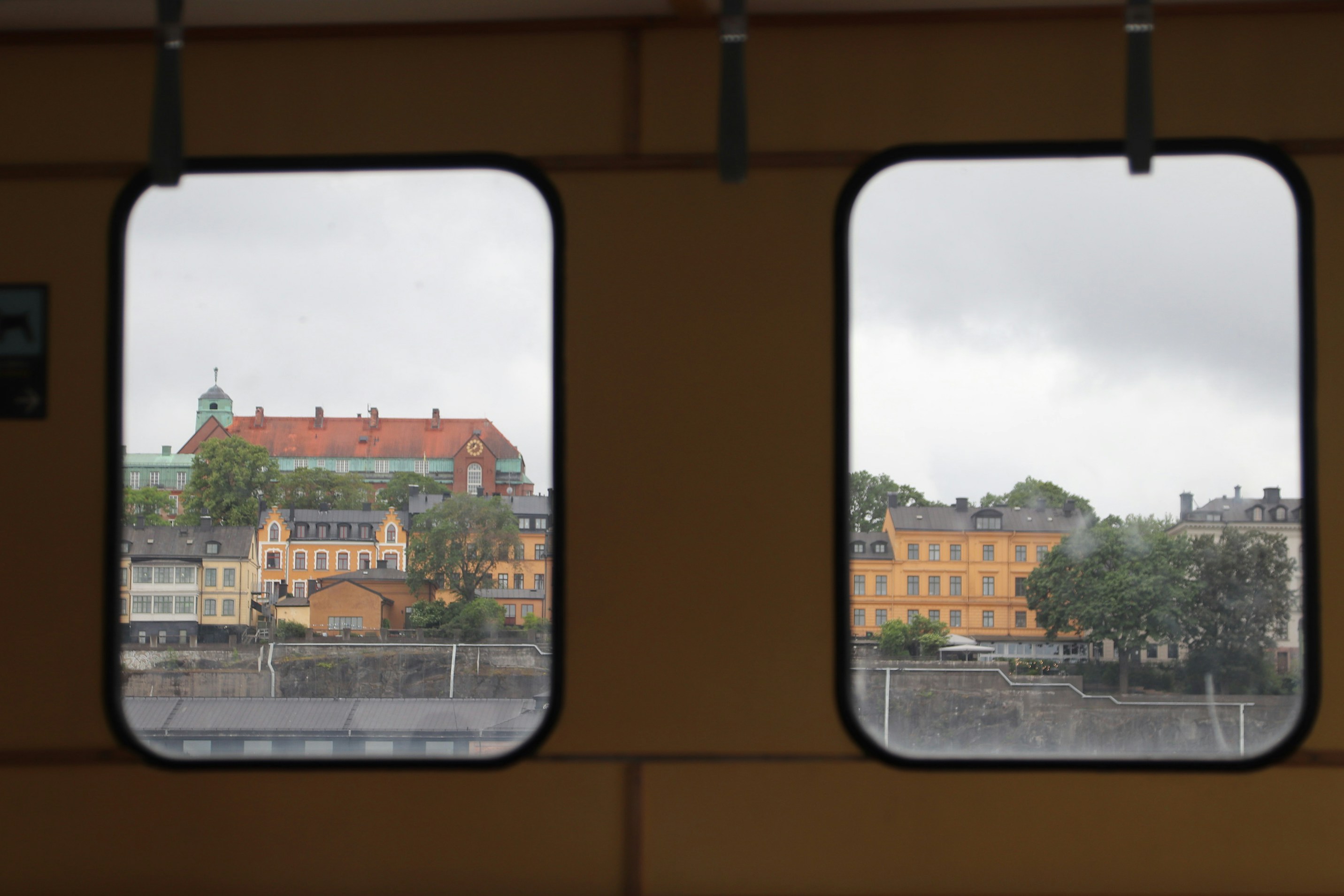 Cityscape visible through train windows.