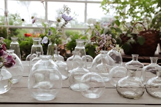 Vases with flowers sit on a table.