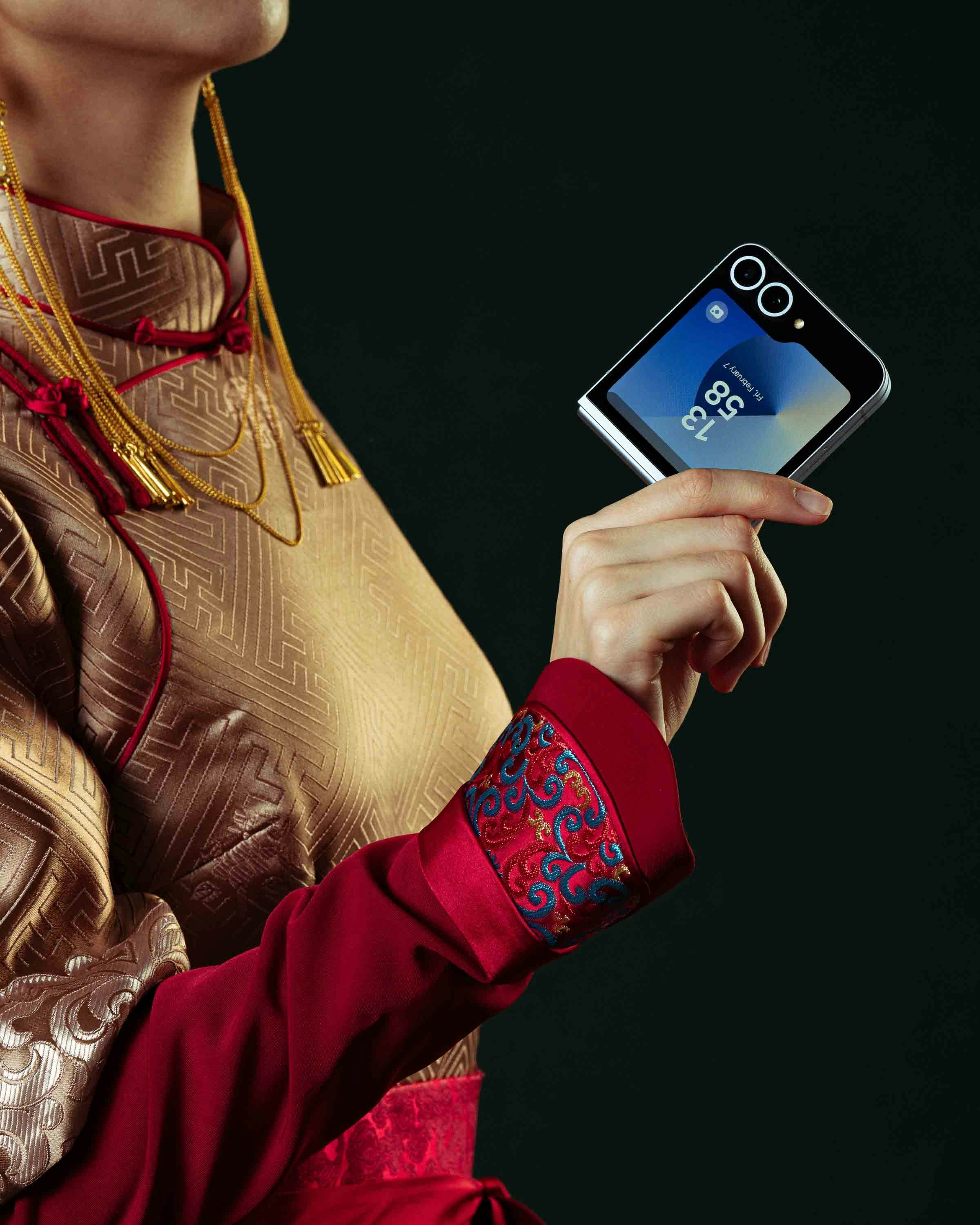 Woman holds a modern smartphone with ornate attire.