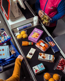 Groceries are being scanned at a supermarket checkout.