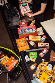 Groceries are laid out on a checkout conveyor belt.