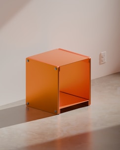 An orange cube-shaped side table is shown.