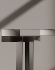 Modern, geometric sculpture is lit by sunlight.
