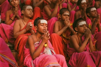 Young monks are praying together in a group.