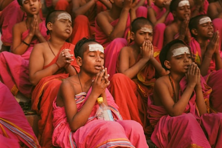Young monks are praying together in a group.