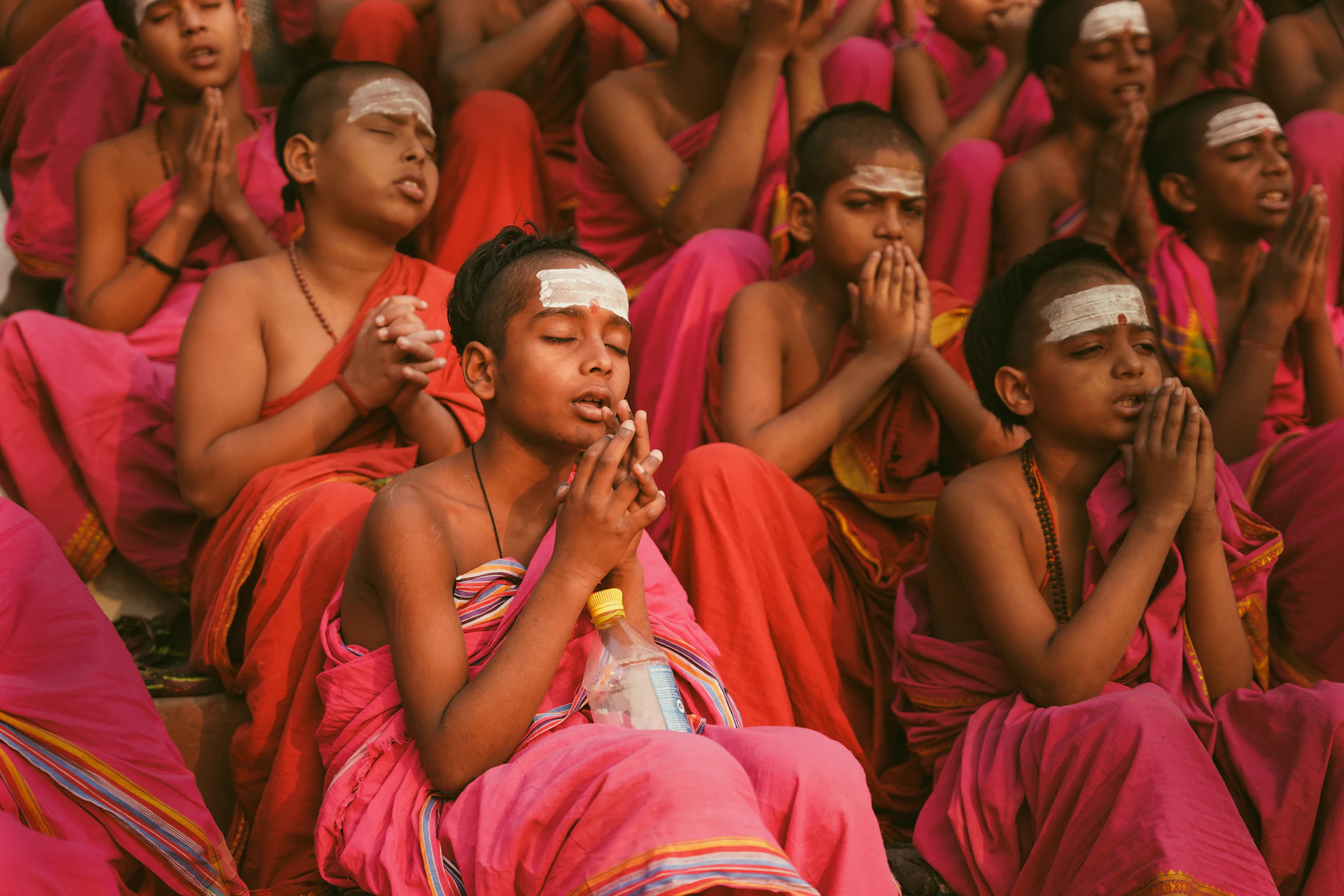 Young monks are praying together in a group