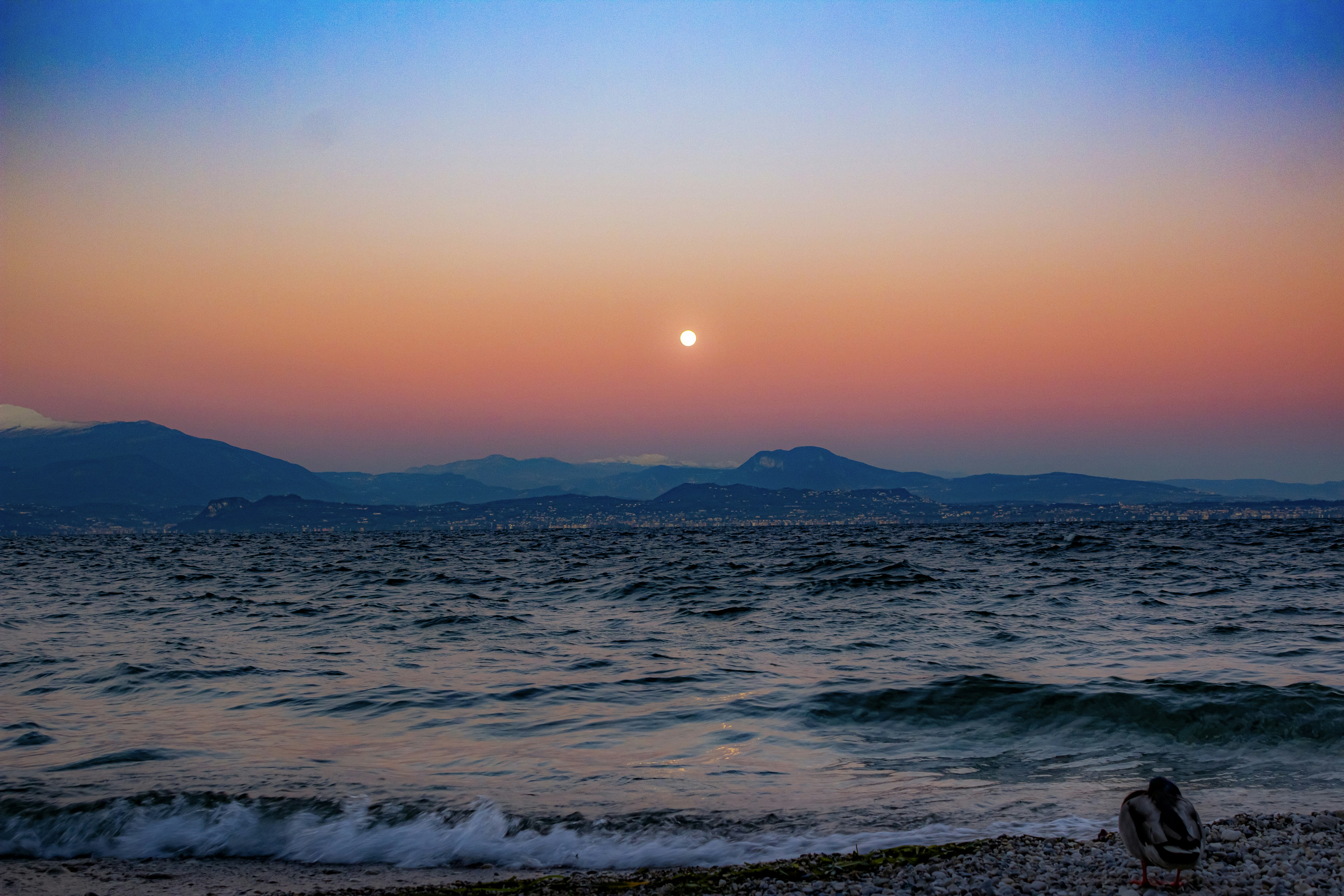 Sunset over the sea with a beautiful orange sky.