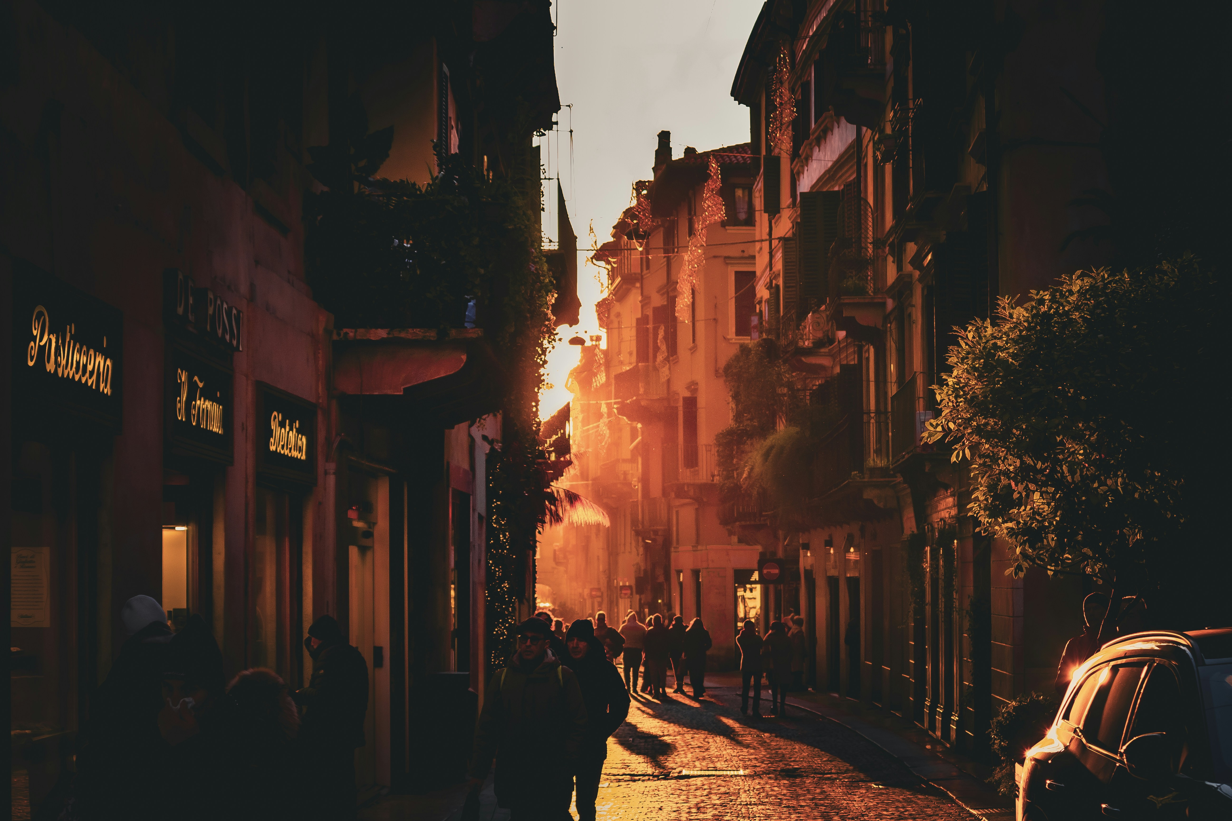 Sunlight streams down a crowded city street.