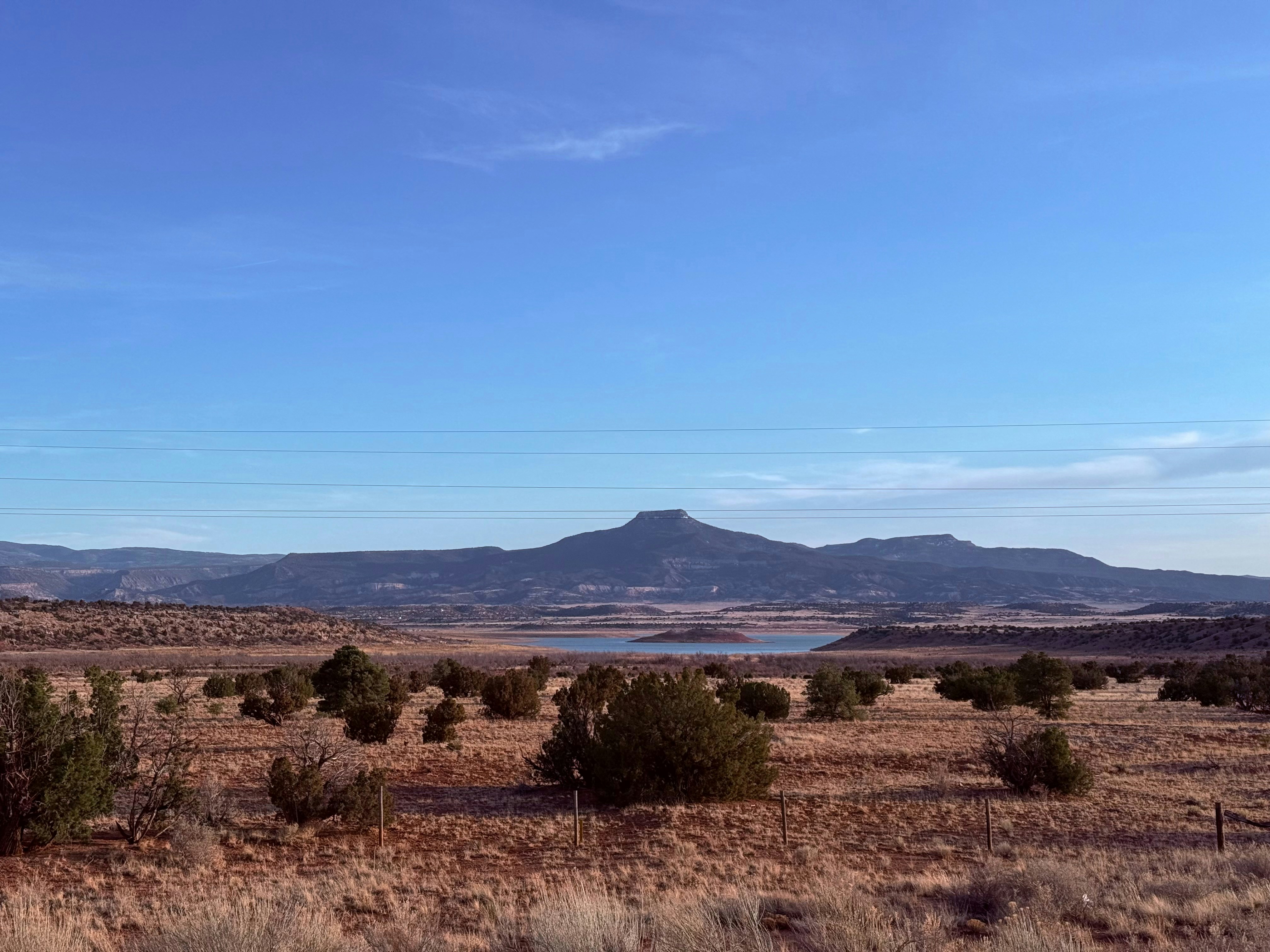 A mountain range stands over a desert landscape.