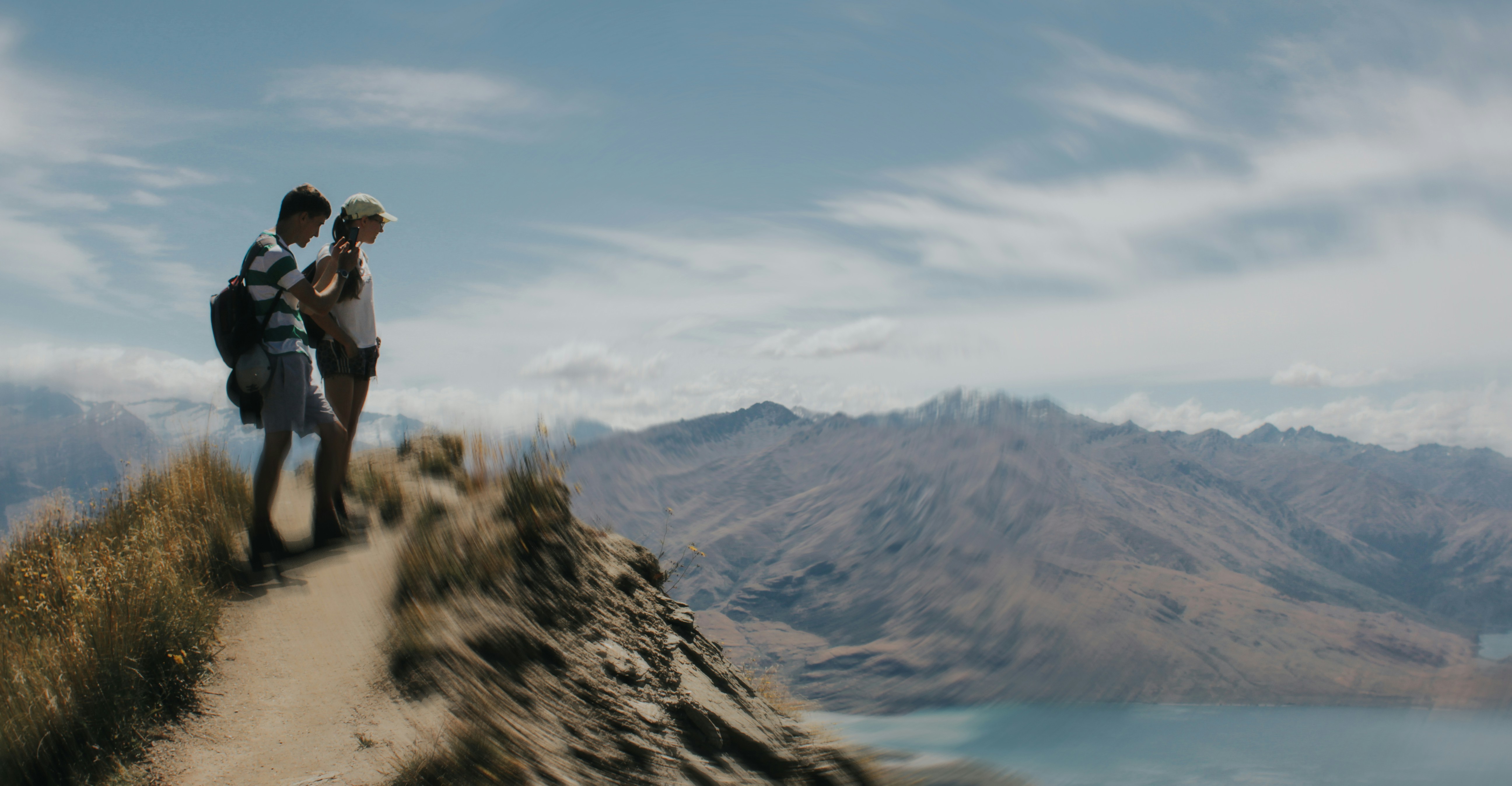 Couple enjoys a scenic view from a mountain top.