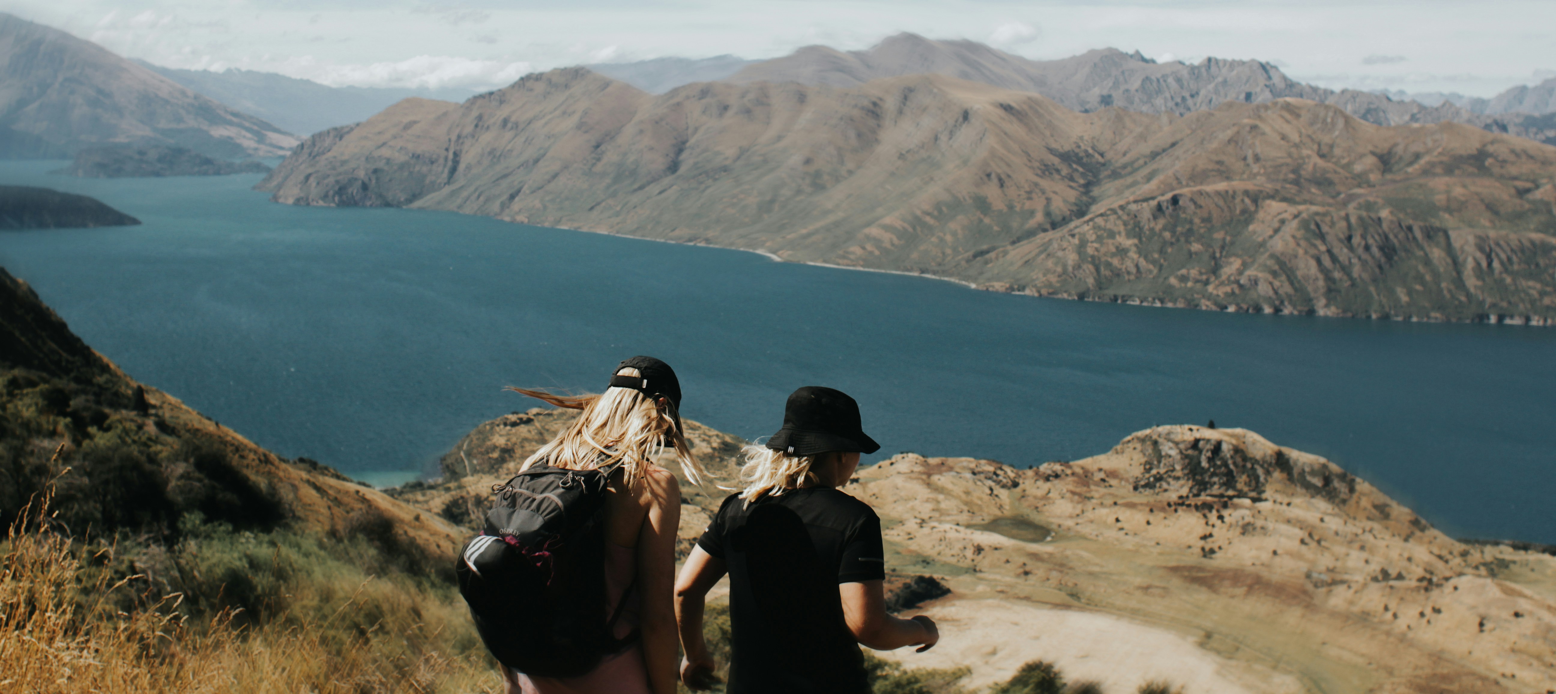 Hikers enjoying a stunning view of a lake.