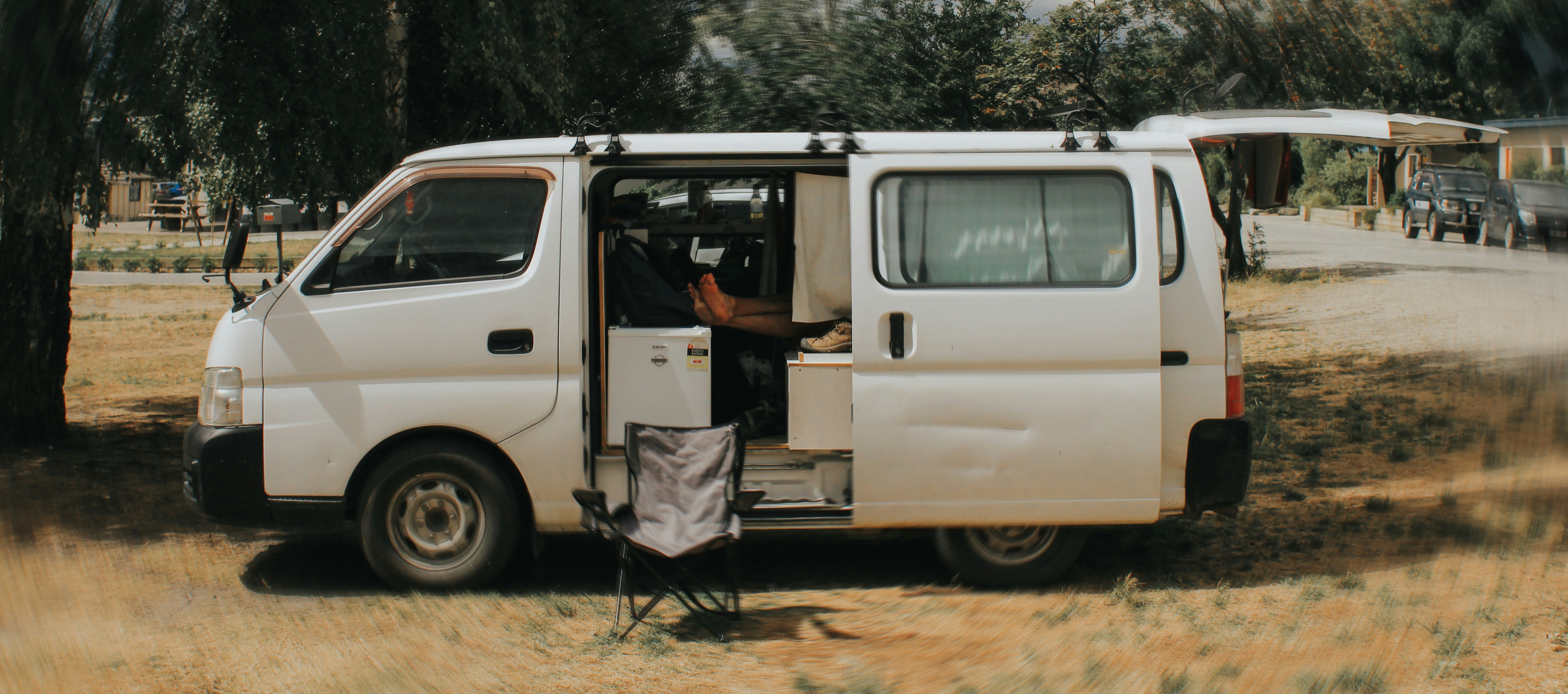 A van is parked with doors open., 