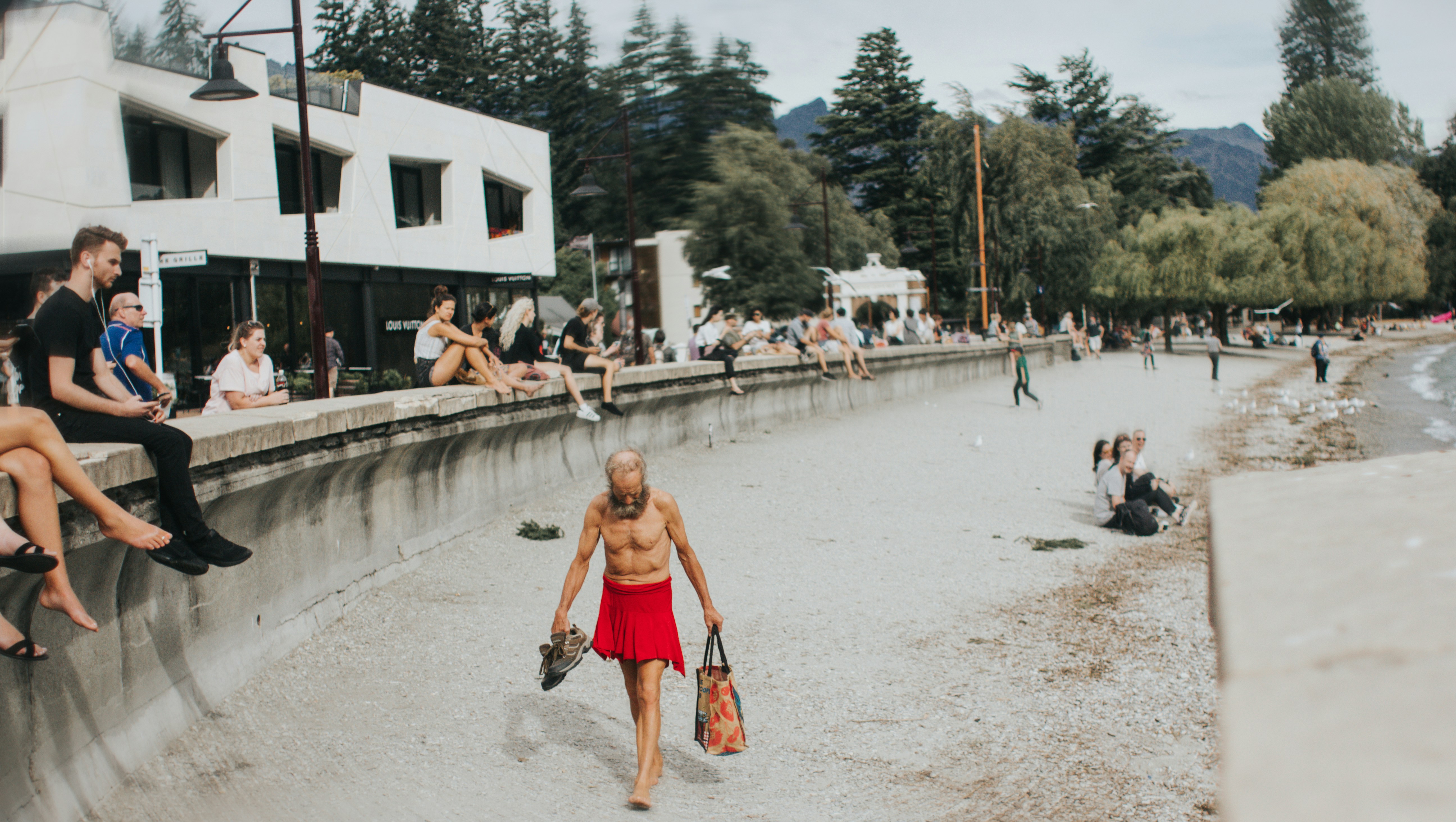 People relaxing on the beach promenade on a sunny day.