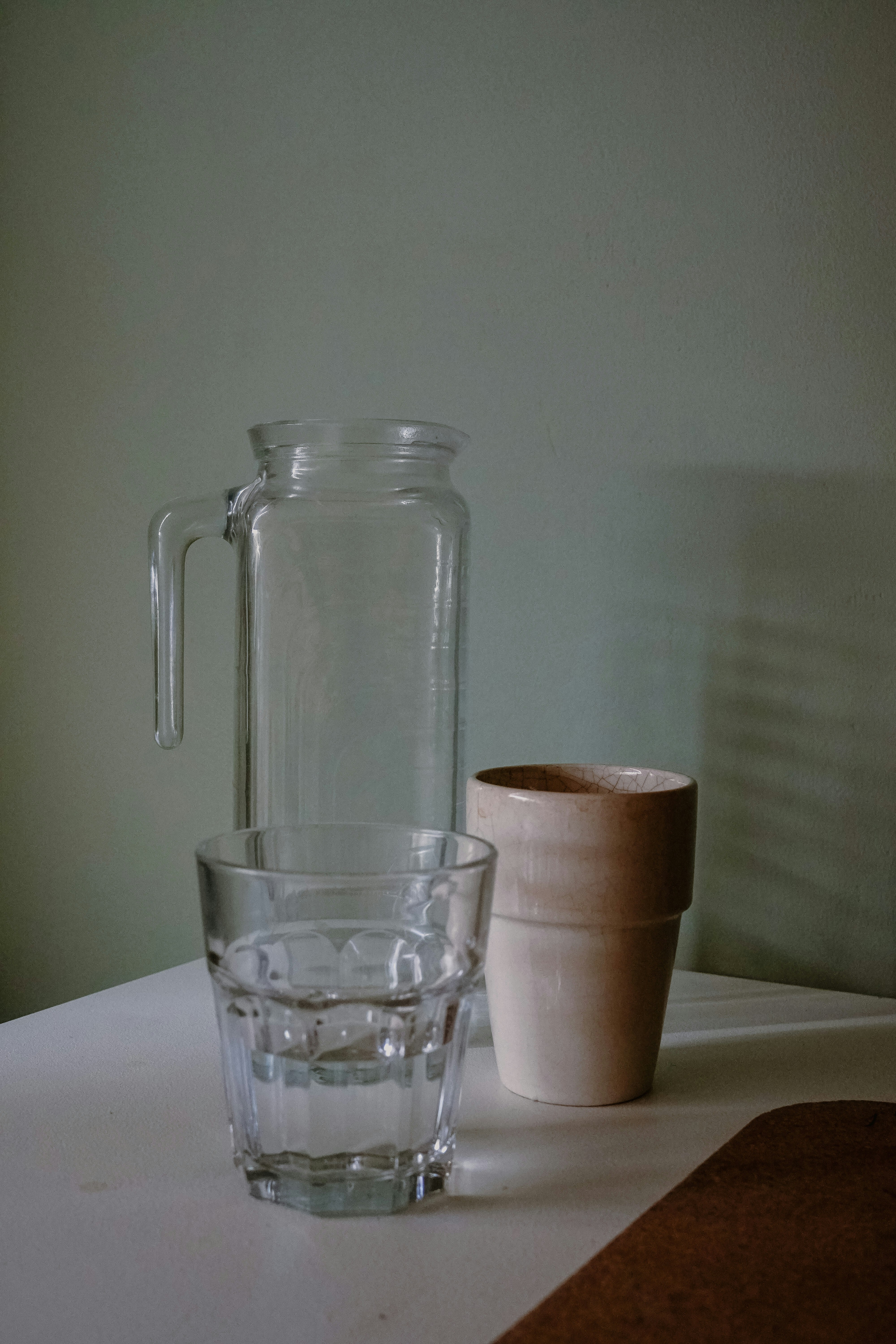 Glasses and a pitcher rest on a table.