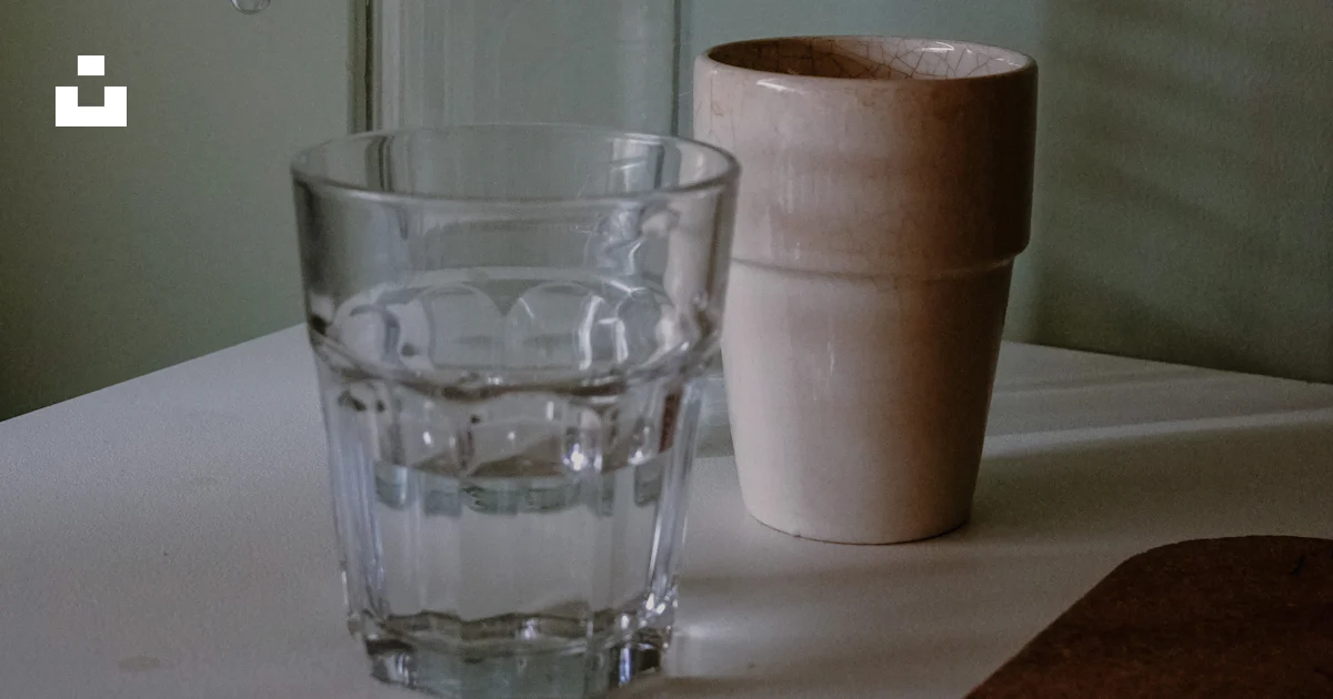 Glasses and a pitcher rest on a table. photo – Free Bottle Image on ...