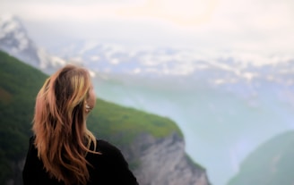 Woman admiring the majestic mountain landscape.