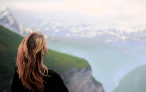 Woman admiring the majestic mountain landscape.