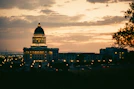The capitol building at sunset, beautifully lit.
