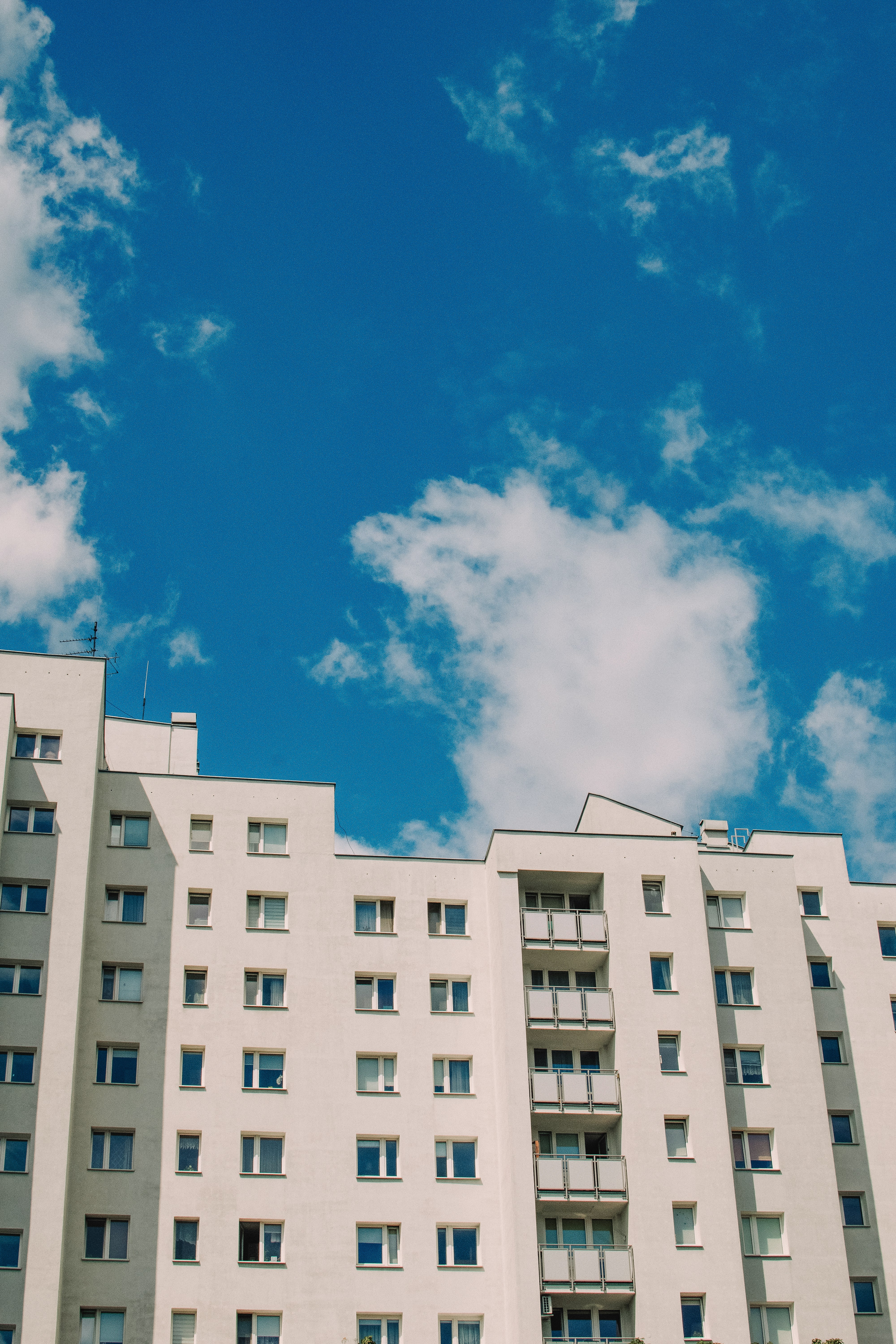 A white building under a bright blue sky.